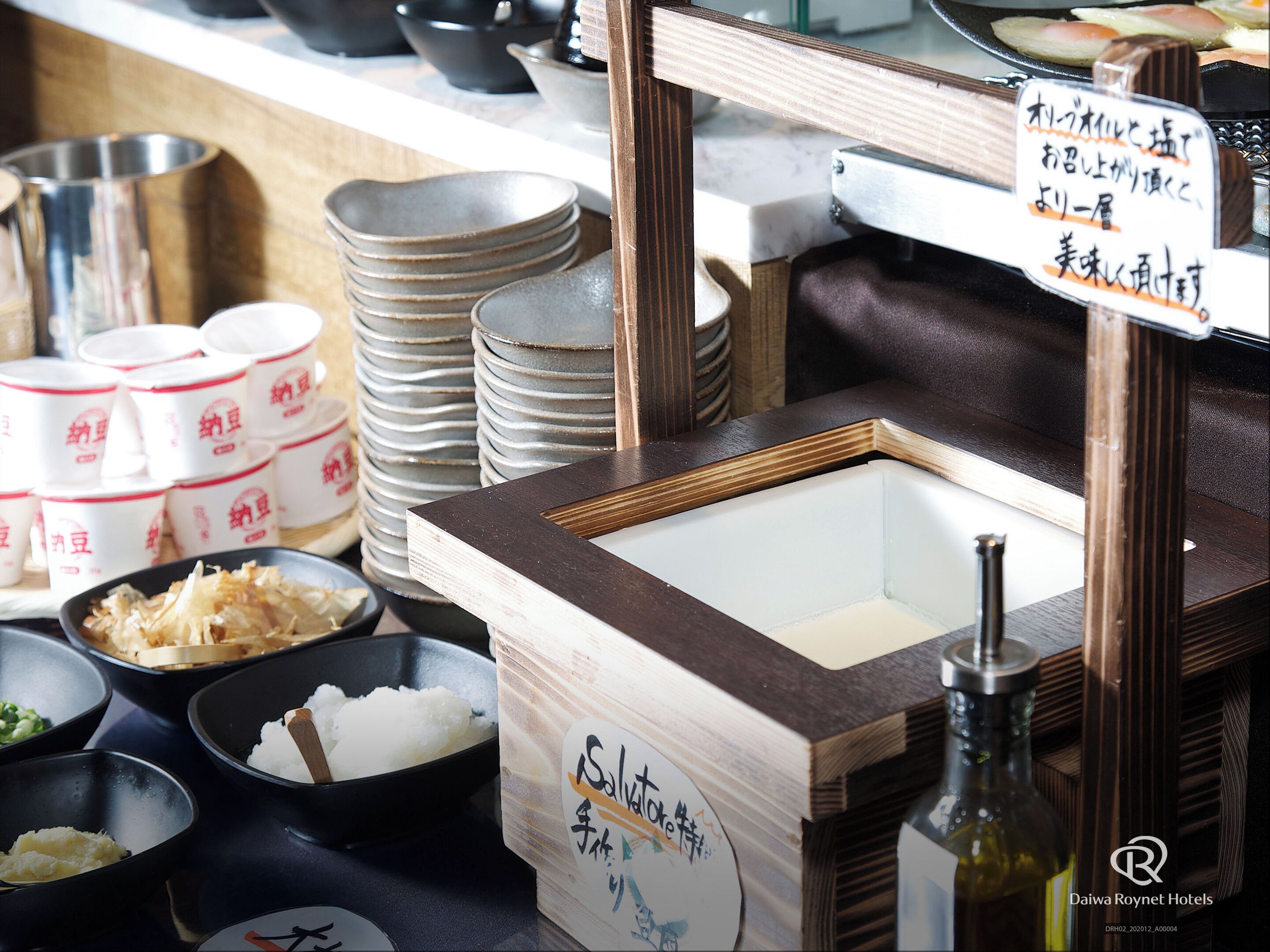 A buffet setup with various dishes and bowls, including rice and other food items.