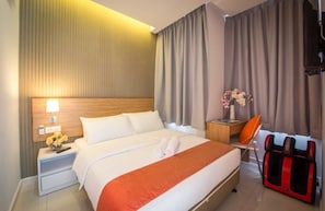 A hotel room with a bed, a nightstand, a massage chair, and a wall-mounted TV. - Sovotel Boutique Hotel (Kuala Lumpur)