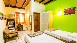 A room with two beds, a desk with a chair, a wardrobe, and a television. - Par May La's Inn (Port of Spain)