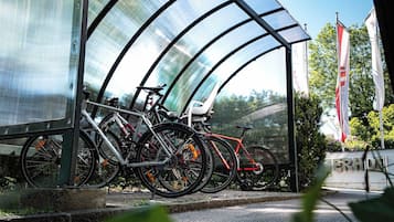 A covered bicycle parking area with multiple bicycles.
