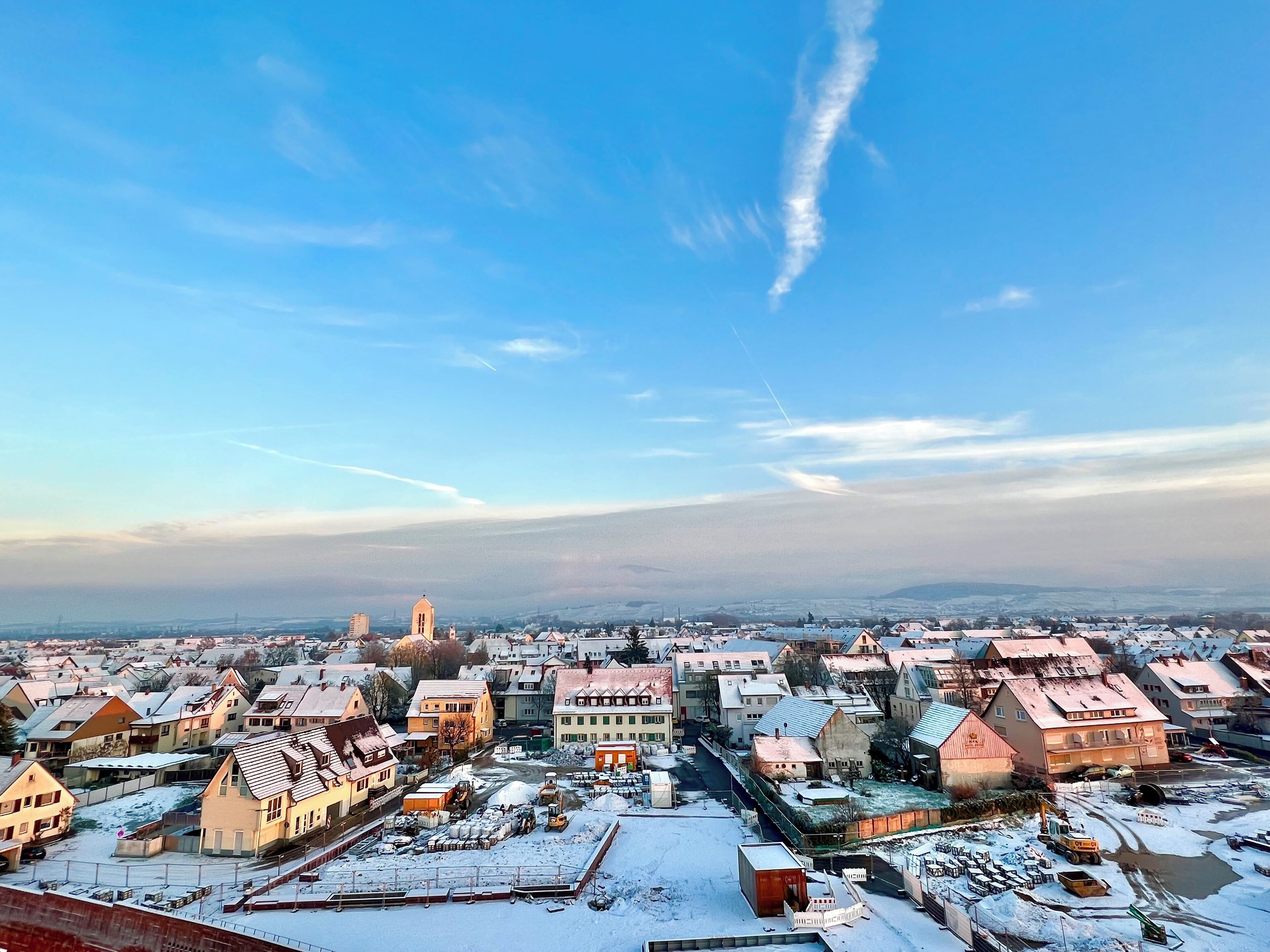 A snow-covered town with historic buildings and a clear sky.