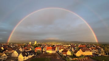 A town with a prominent rainbow arching over it.