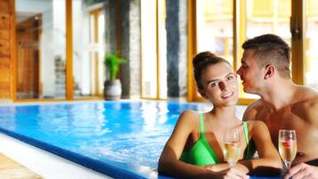 Indoor pool, open 9:00 AM to 10:00 PM, pool umbrellas, pool loungers