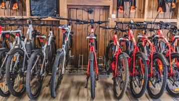 Bicycles parked in a wooden room with a wooden floor.