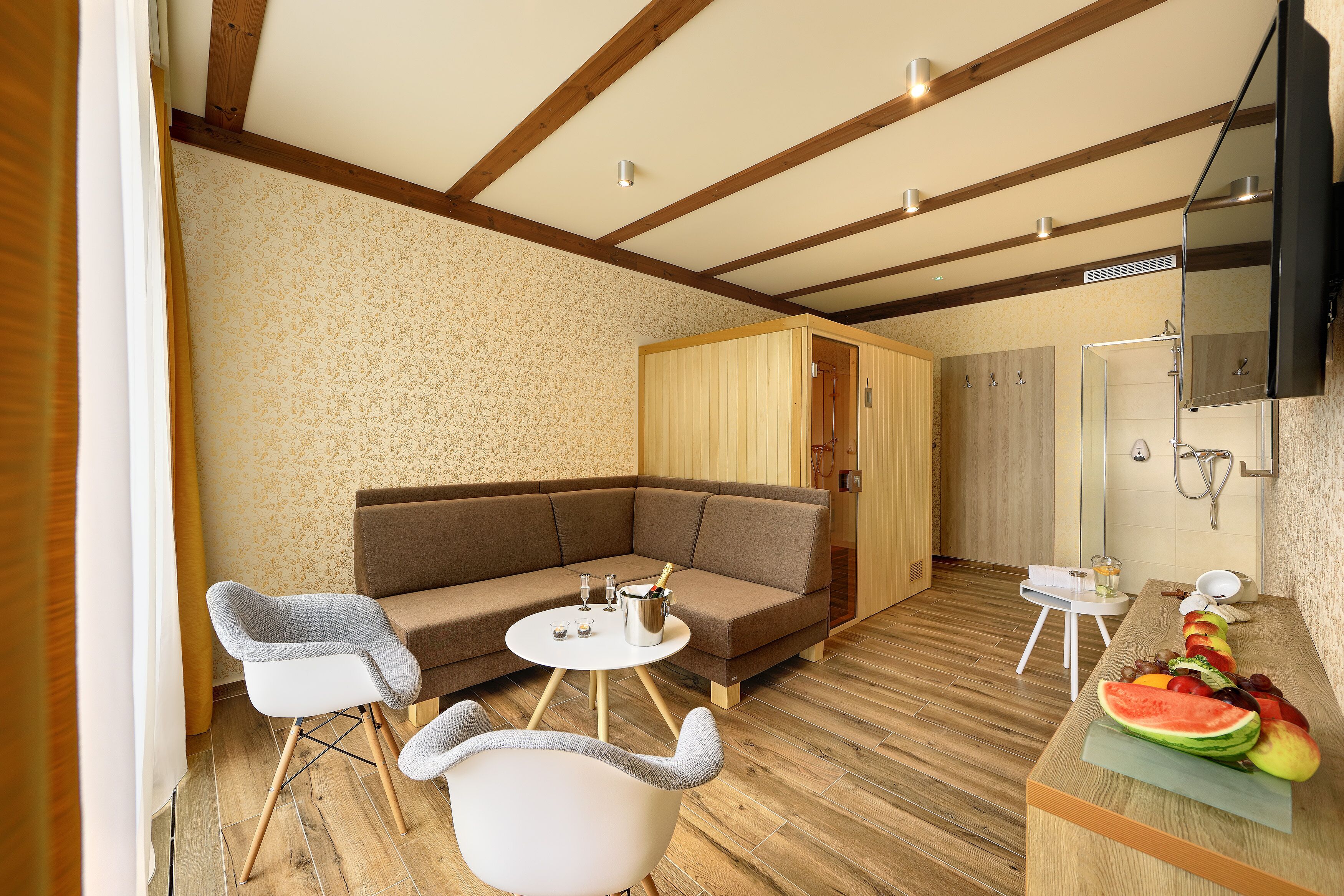 A modern living area with a sectional sofa, a small round table, and a white chair.