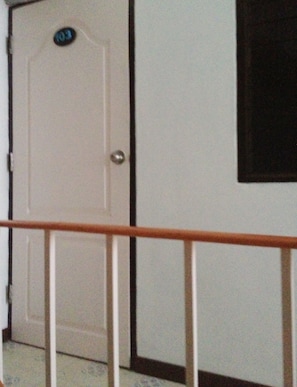 Enter your room through this door, featuring a balcony with a view.