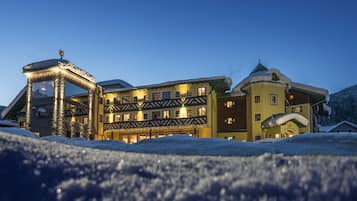 Experience the charm of this traditional alpine hotel, featuring a classic facade with multiple windows and balconies.