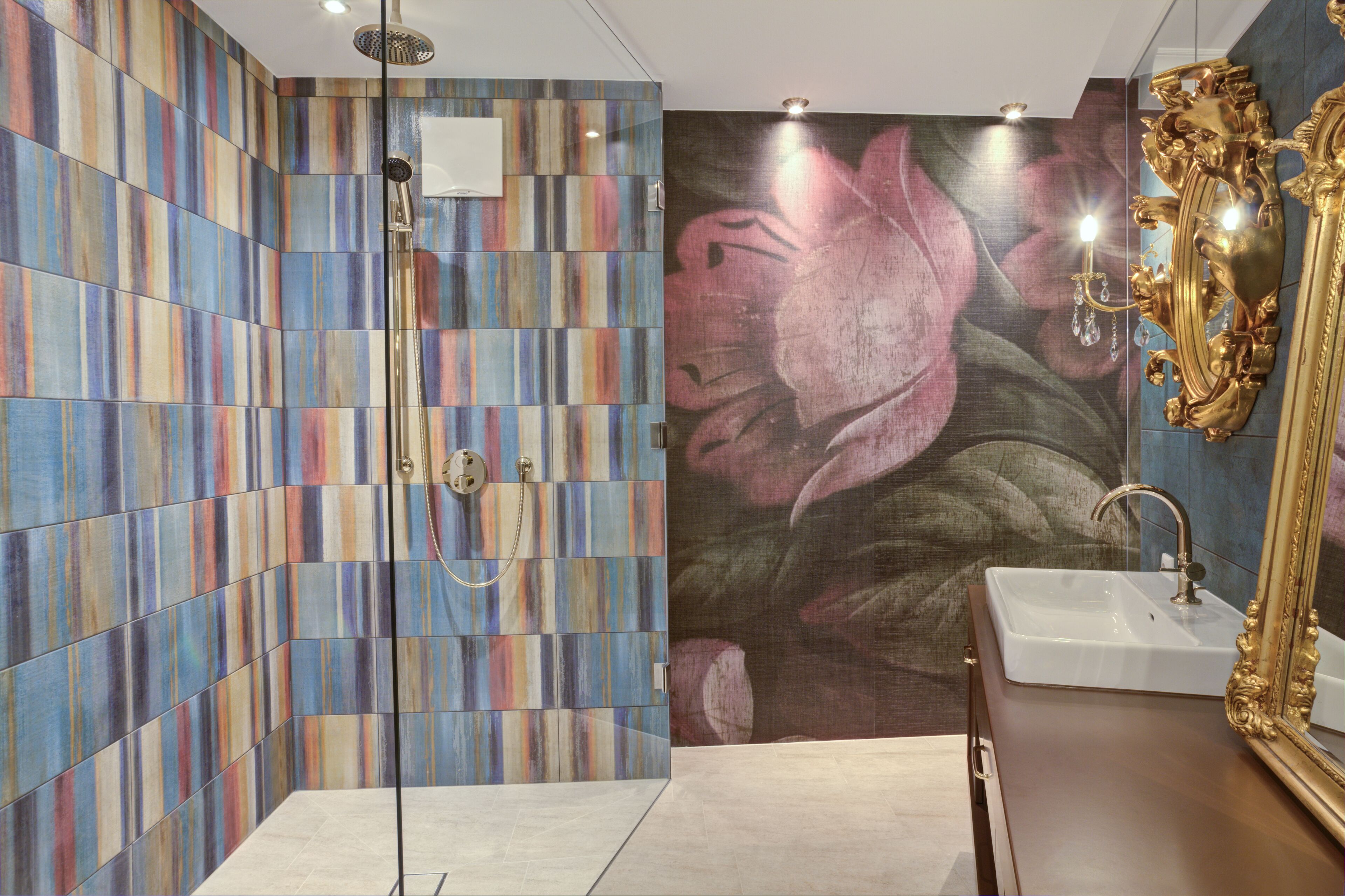A bathroom with a shower, a sink, and a large mirror.