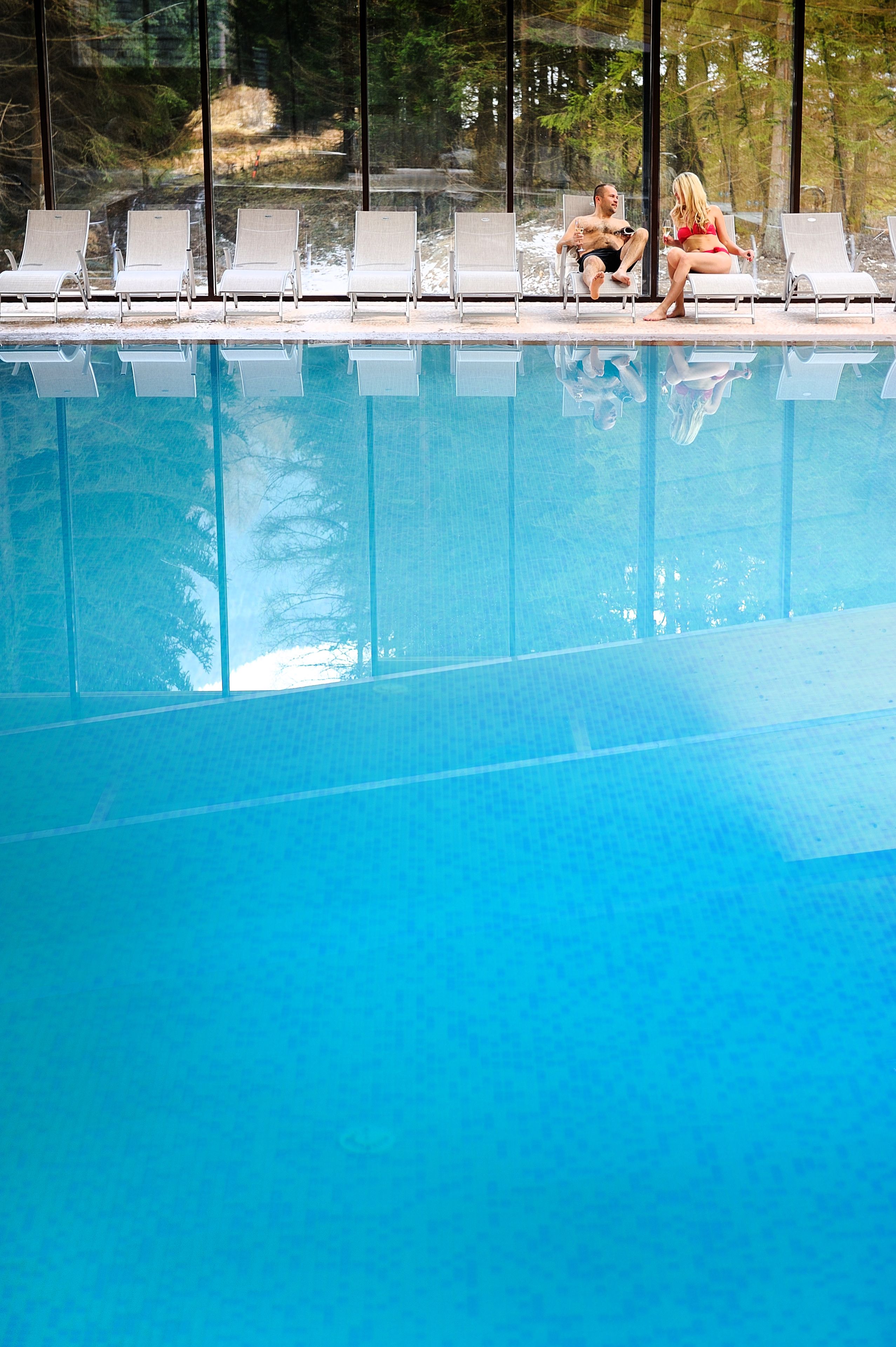 A poolside area with lounge chairs and a clear view of the pool.