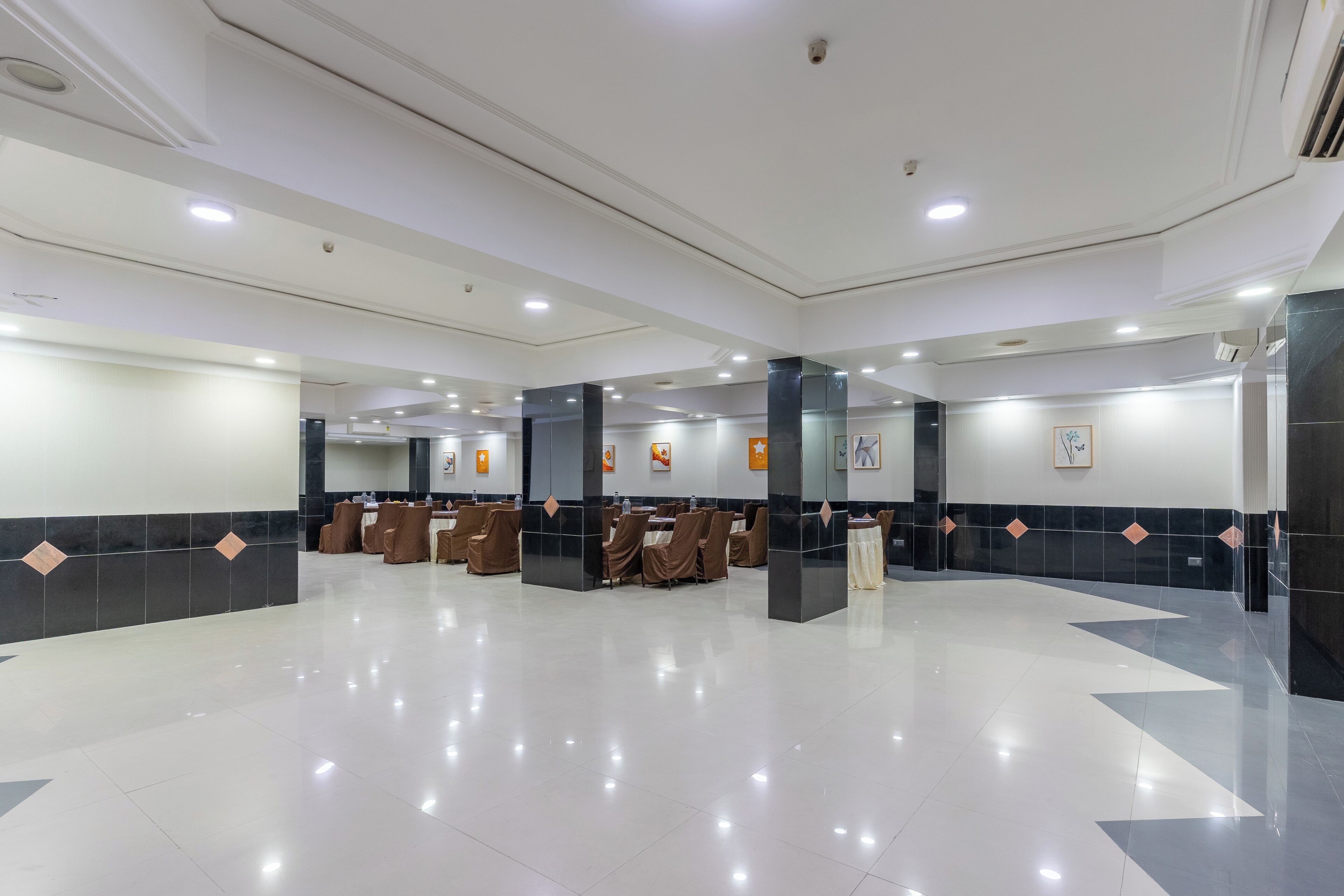A spacious lobby with a polished floor, seating areas, and a reception desk.