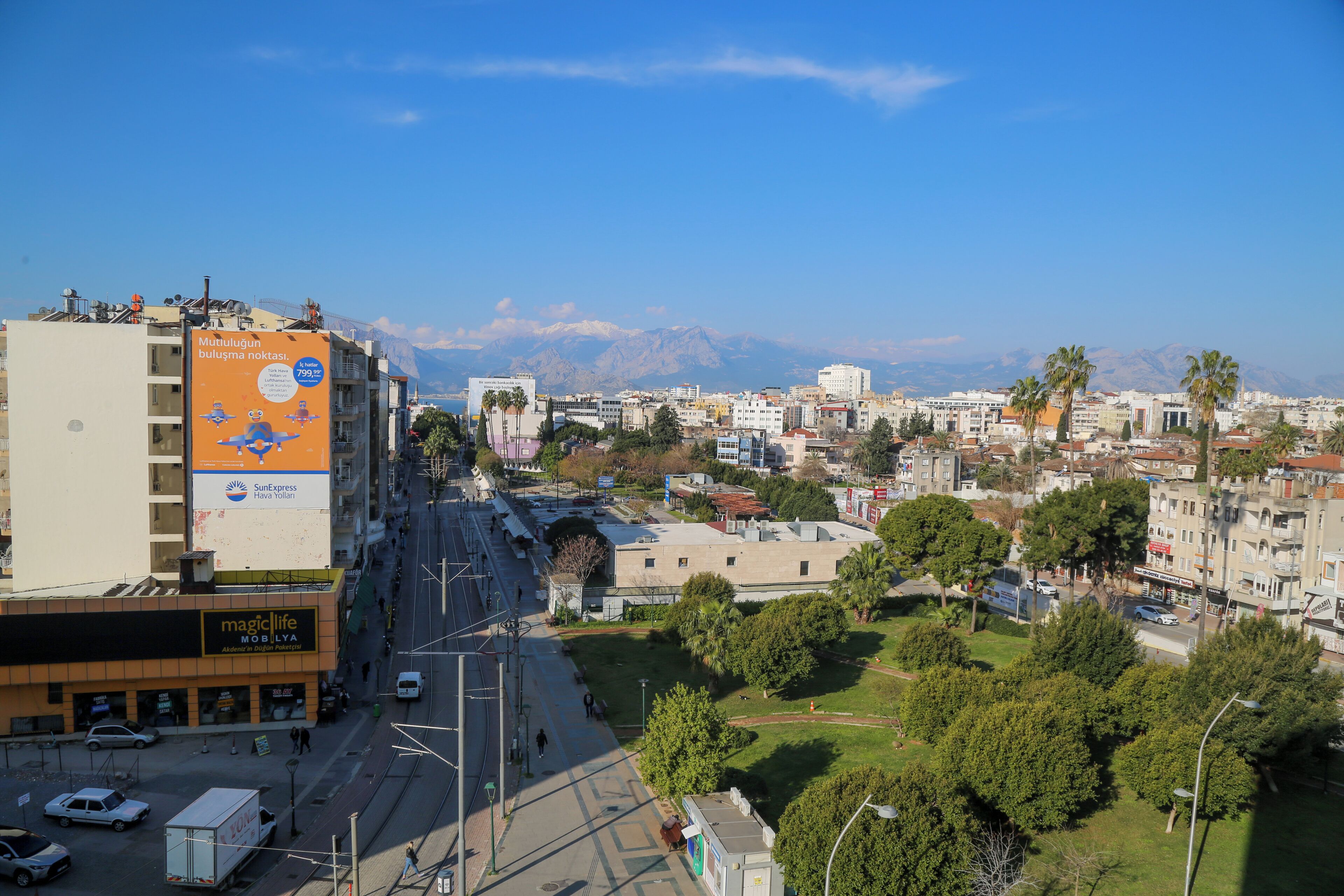 A cityscape with a prominent building featuring a large advertisement.
