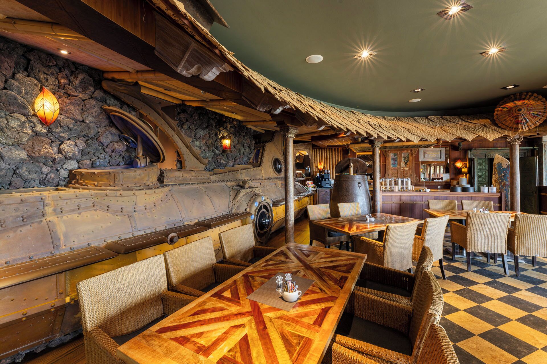 A restaurant with rustic decor, stone walls, and wooden furniture.