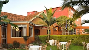 A building with a red facade and a sign that reads "PLACES". - Eureka Place Hotel (Kampala)