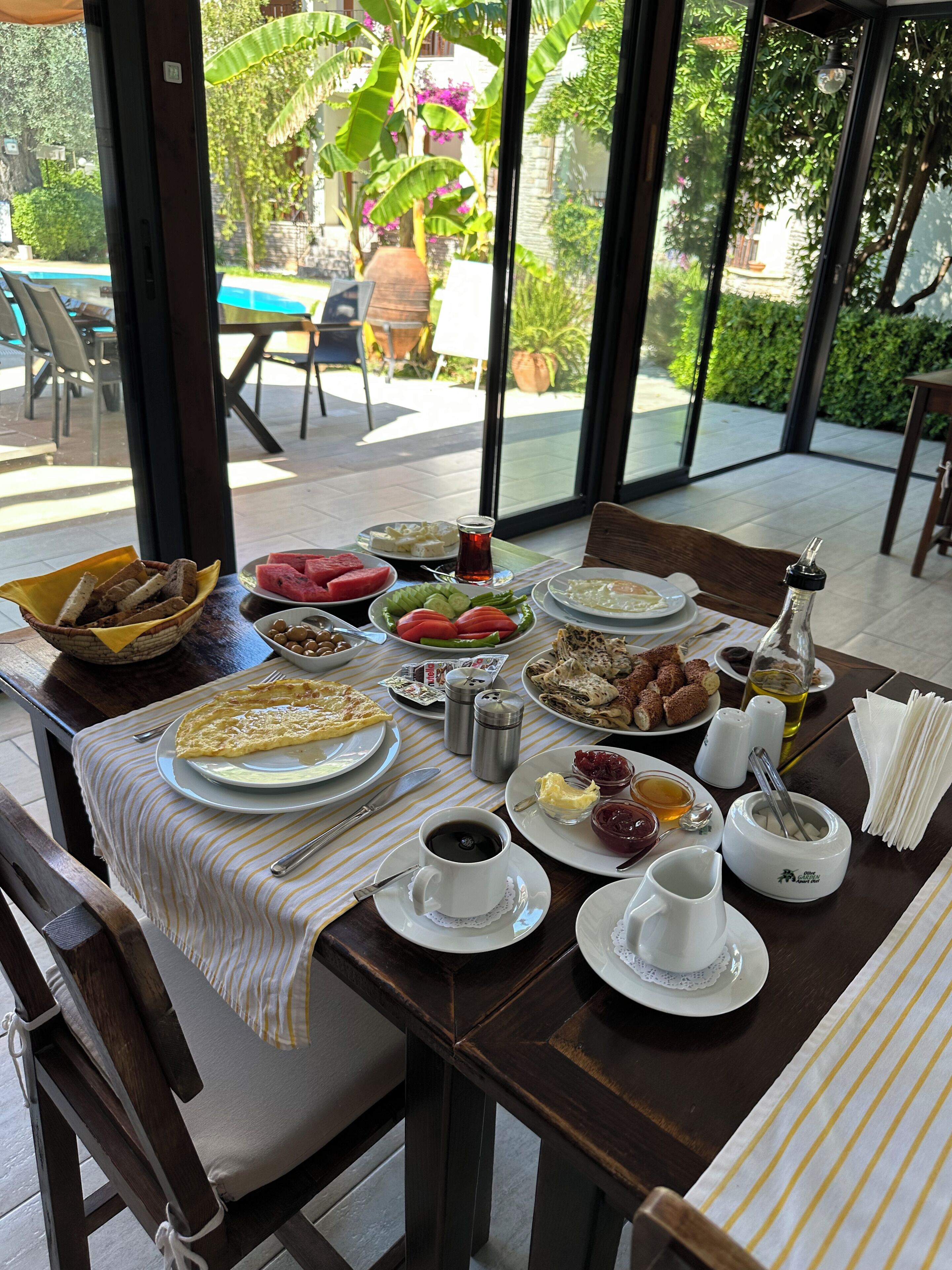 A dining table set with various dishes, a coffee cup, and condiments.