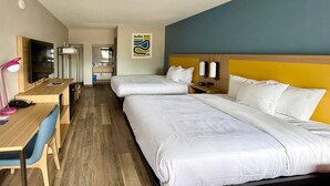 A hotel room with two beds, a desk with a chair, a television, and a bathroom visible in the background. - Park Inn by Radisson, Weldon - Roanoke Rapids (Weldon)