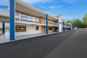A multi-story parking structure with a 'Park Inn by Radisson' sign, featuring a flat roof and a series of balconies. - Park Inn by Radisson, Weldon - Roanoke Rapids (Weldon)