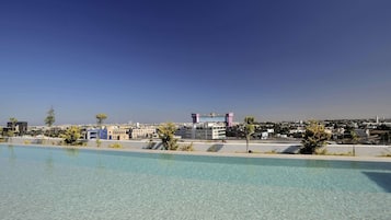Outdoor pool, open 10:00 AM to 11:00 PM, pool umbrellas, sun loungers