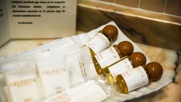 A tray of bath products including bottles and tubes labeled 'Daria'.