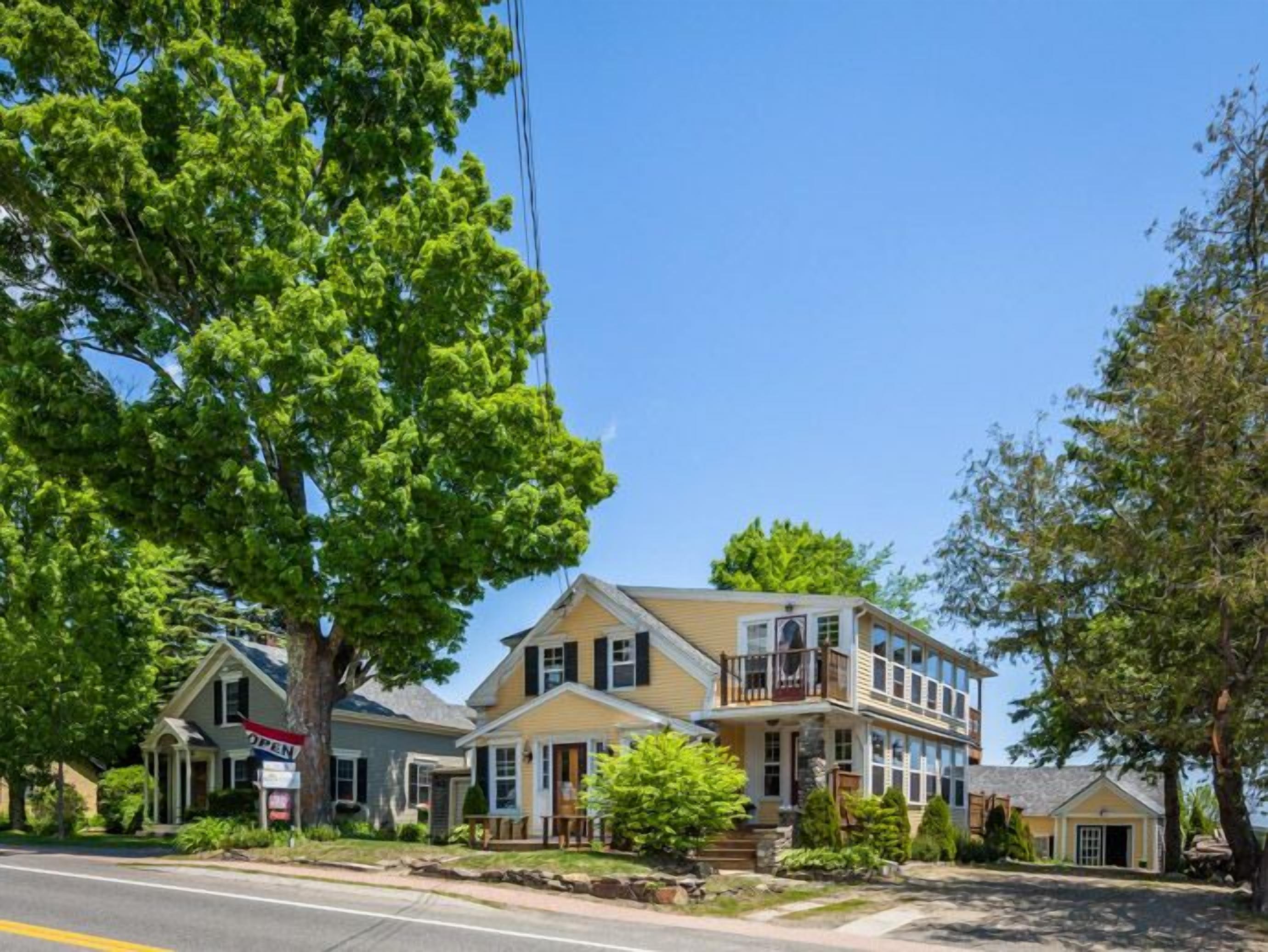 A two-story house with a front porch, a garage, and a small attached garage.