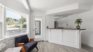 A modern kitchen with a wooden countertop and a potted plant. - Harkness Brook Inn (Rockport)