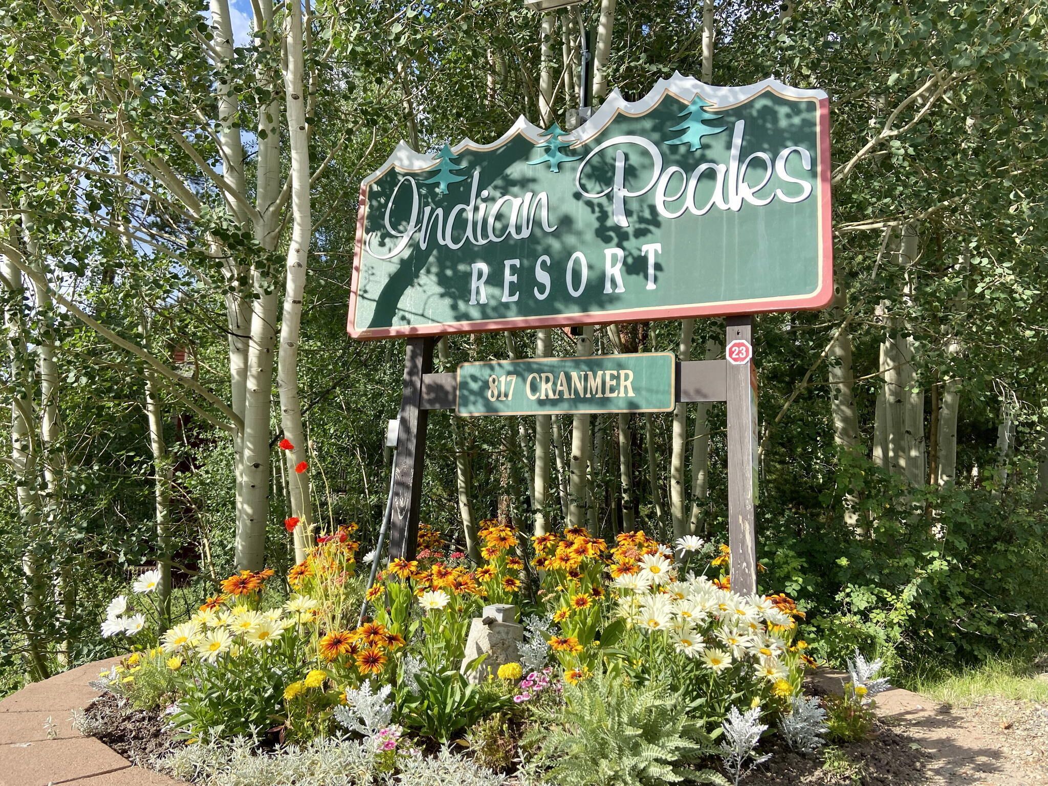 A sign for Indian Peaks Resort with a street address of 817 Cranmer.