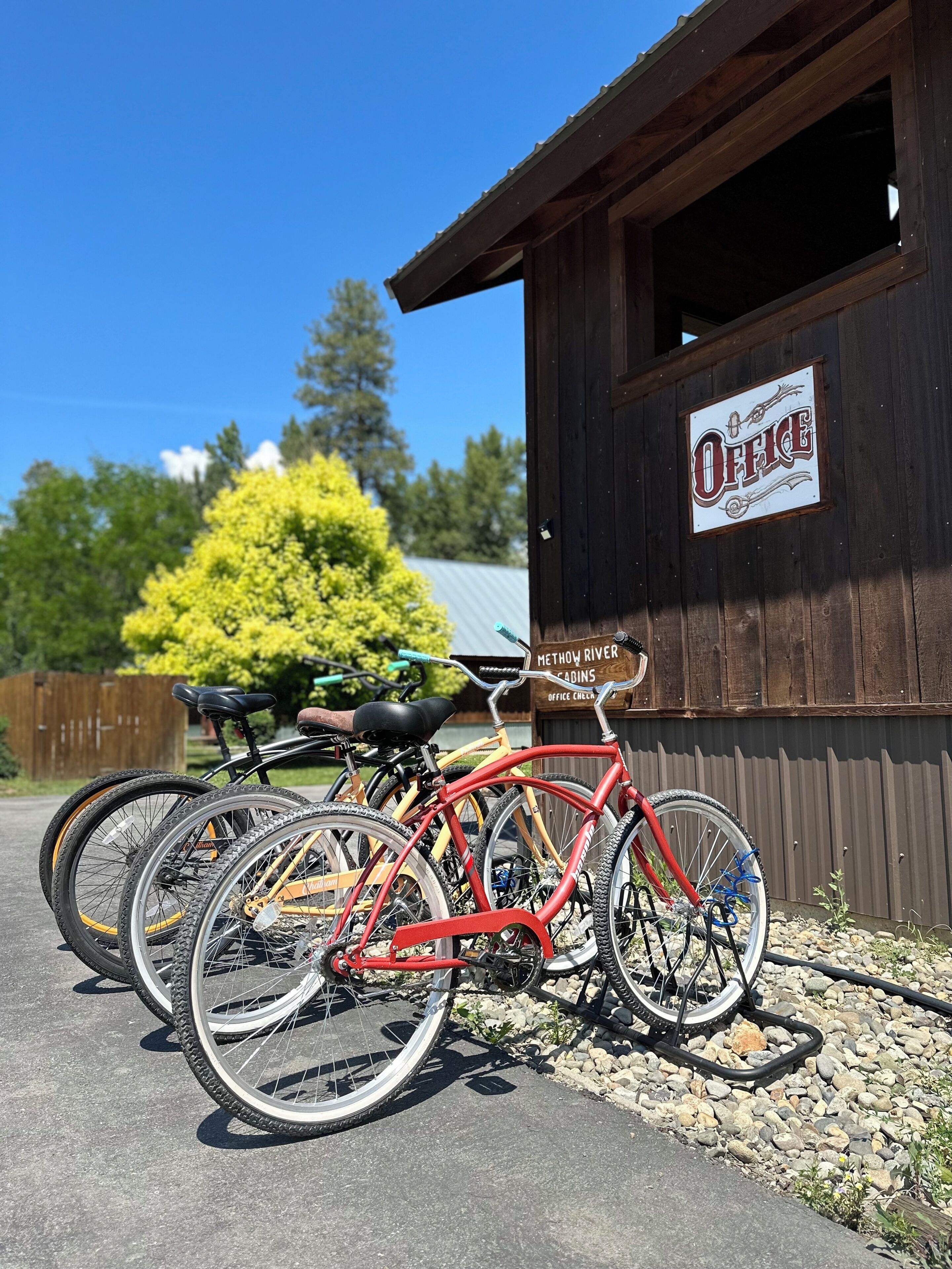 A wooden building with a sign reading "Office" and "Methow River Cabins."