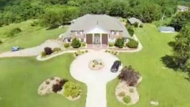 A large house with a driveway, surrounded by greenery. - Lafayette Grand Manor (Waynesville)