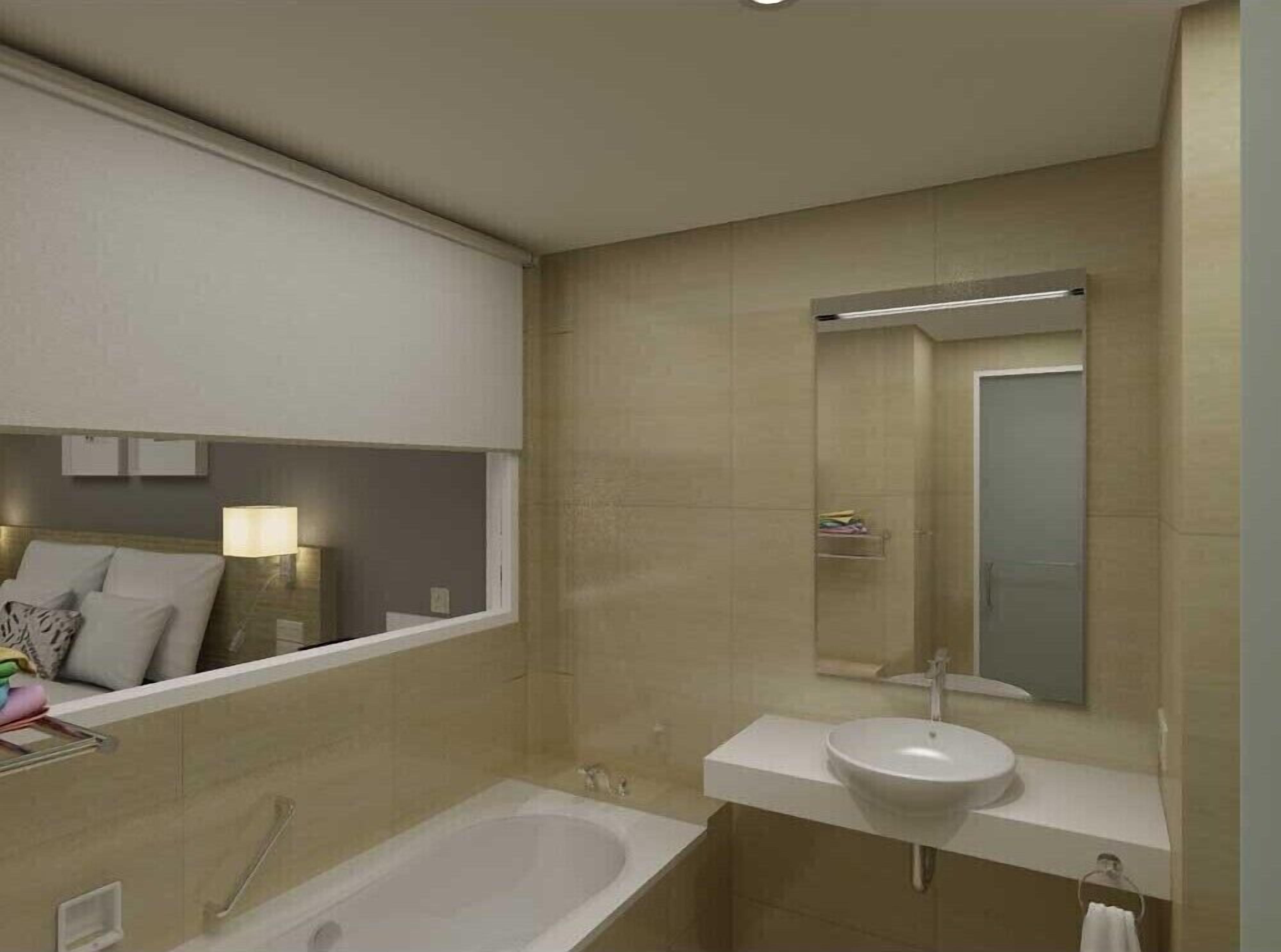 A modern bathroom with a bathtub, a sink, and a mirror.