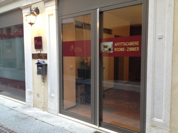A hotel entrance with a glass door displaying the name 'AFFITTACAMERE ROOMS - ZIMMER'. - Hotel Leon D'Oro (Mantua)