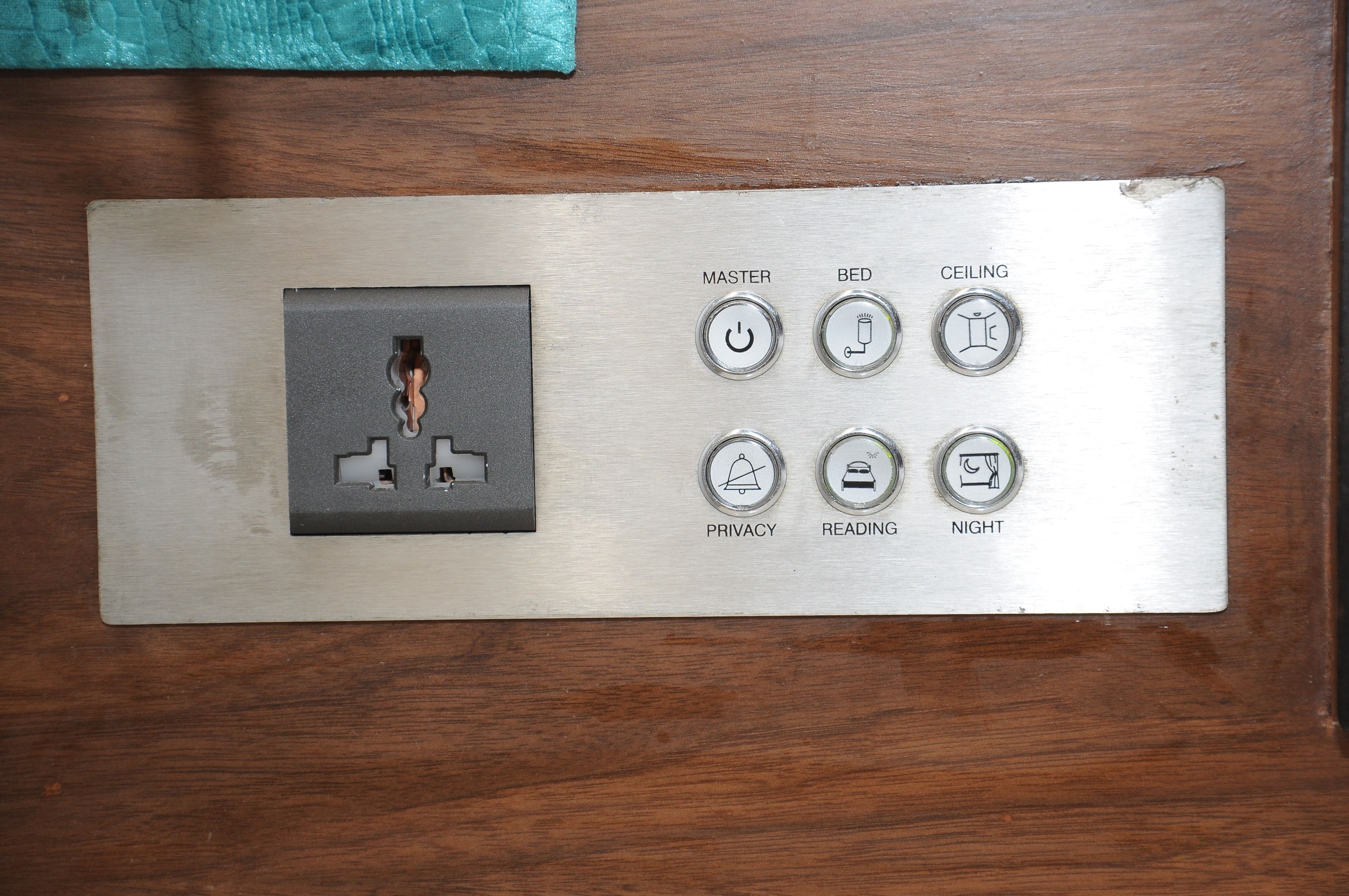 A control panel with a photo slot, master switch, bed, ceiling, privacy, reading, and night lights.
