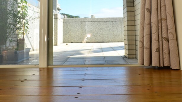 An open sliding glass door leading to a balcony with a clear sky view. - Fishfun House (Hualien City)