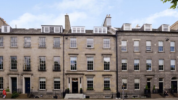A row of traditional stone buildings with uniform window patterns and a central entrance. - Destiny Scotland - Q-Residence (Edinburgh)