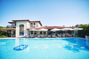 Indoor pool, outdoor pool, pool umbrellas, pool loungers