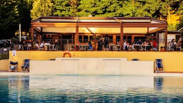 Seasonal outdoor pool, open 10:00 AM to 8:00 PM, pool umbrellas