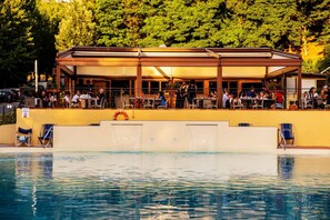 Ein Poolrestaurant mit Außenbereich und Rettungsschwimmerstation.