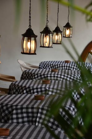 A bed with checkered bedding and three hanging lanterns above it. - Golden Lodge Tangalle (Tangalle)
