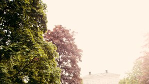 A group of people hugging in a grassy area with a building in the background. - Söråkers Herrgård (Soraker)