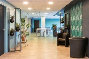 A modern office space with a long corridor, wooden flooring, and black chairs. - Sure Hotel by Best Western Saint-Amand-Les-Eaux (Saint-Amand-les-Eaux)