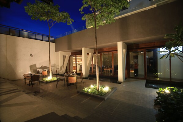 An outdoor patio area with seating and a small water feature.