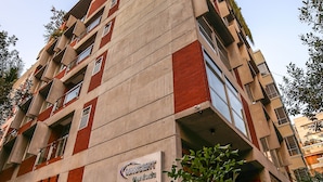 A multi-story building with a sign indicating it is a hotel. - Nascent Gardenia Suites (Dhaka)