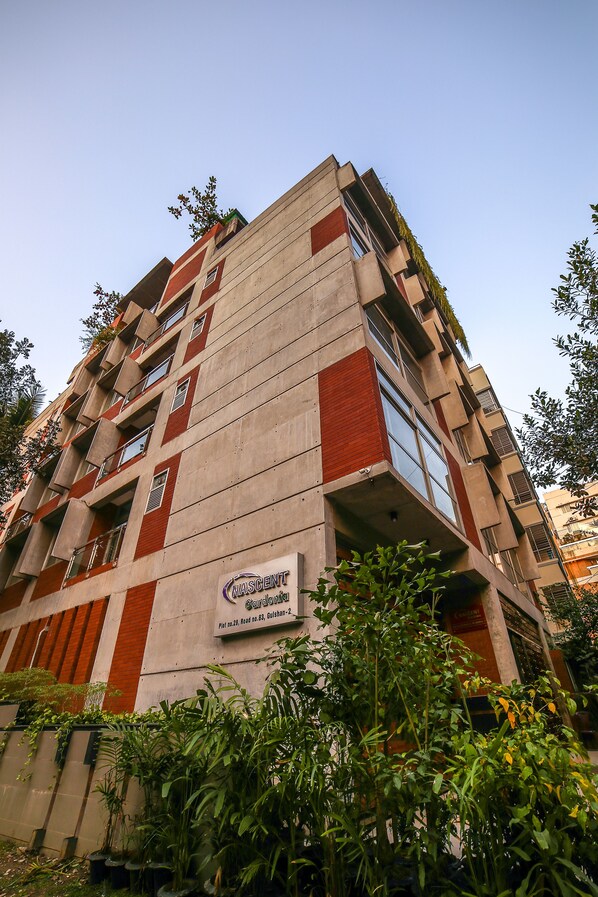 A multi-story building with a sign indicating it is a hotel.