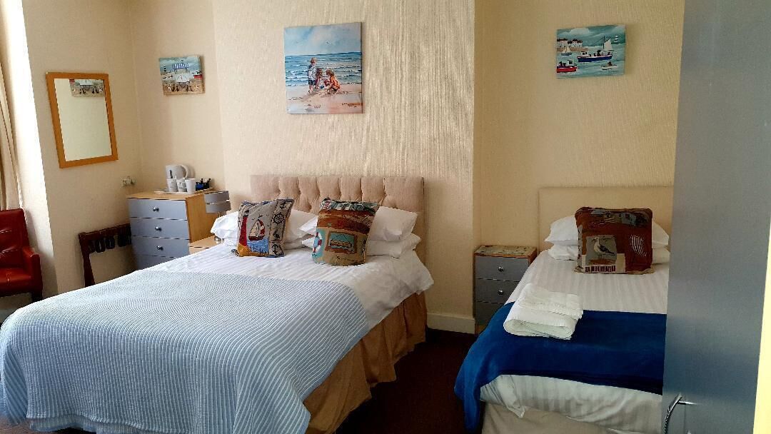 family room | desk, iron/ironing board, bed sheets