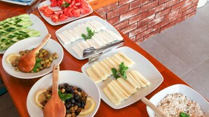A buffet table with various food items and utensils. - Dedeminn Garden Hotel (Fethiye)