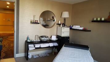 Comfortable room with a neatly arranged bed, desk, and mirror.