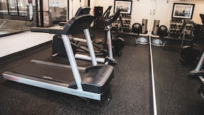 A gym with treadmills, weight machines, and a mirrored wall. - Holiday Inn Express & Suites Cumberland - La Vale by IHG (Cumberland)