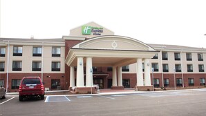 A Holiday Inn Express & Suites building with a covered entrance, multiple windows, and a parking lot. - Holiday Inn Express & Suites Cumberland - La Vale by IHG (Cumberland)