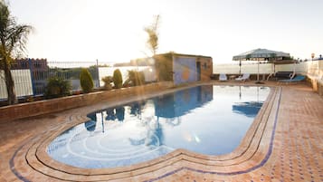 Seasonal outdoor pool, open 9:00 AM to midnight, pool umbrellas