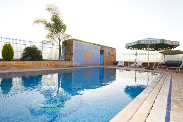 Seasonal outdoor pool, open 9:00 AM to midnight, pool umbrellas