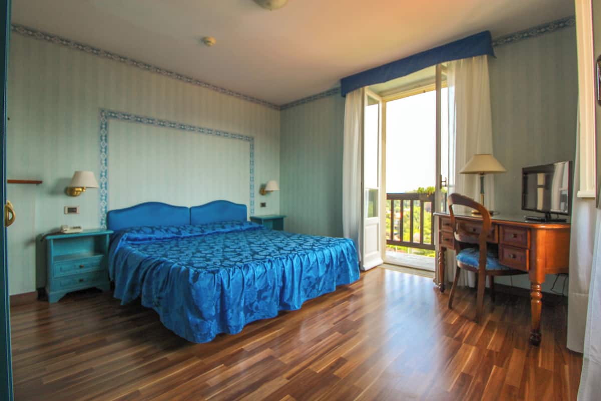 Une chambre à coucher avec un grand lit, un bureau et une chaise.