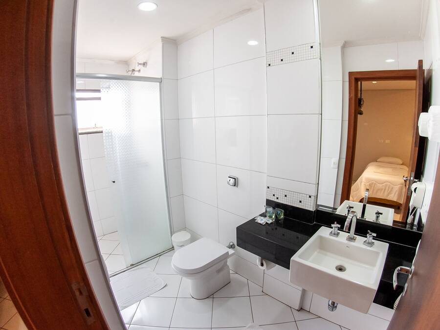 A modern bathroom with a toilet, sink, and shower.